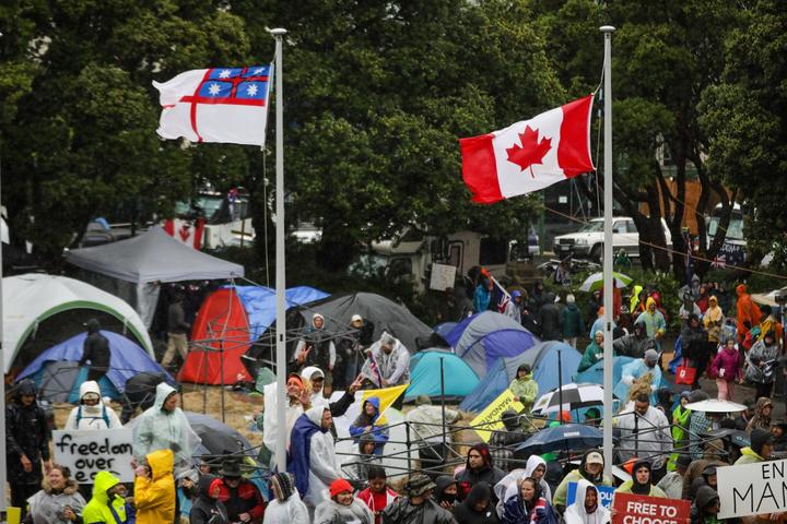 Canada and United Tribe flags at anti-mandate protest